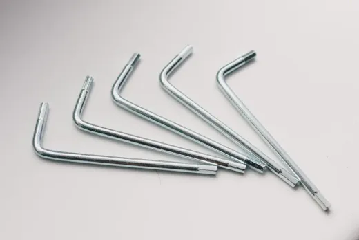 Four silver hex keys on a light surface